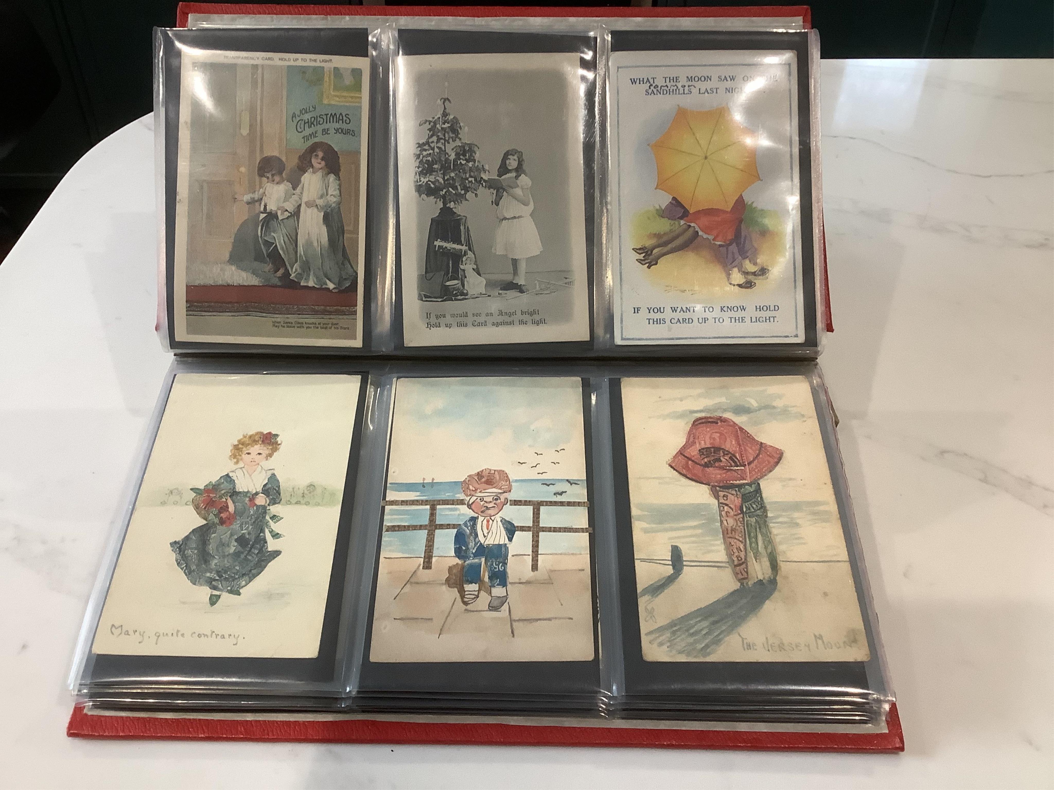 An album of assorted novelty postcards, including Louis Wayne cats, fantasy heads, silks, 1870 advertisement and 1891 Royal Naval Exhibition (97)